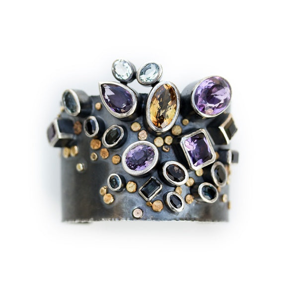 Handmade one of a kind bangle in oxidized sterling silver with Amethyst, Citrine, Topaz, Tourmaline, and Sapphire with 18K Gold dots