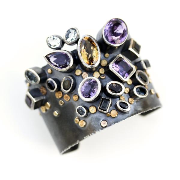 Handmade one of a kind bangle in oxidized sterling silver with Amethyst, Citrine, Topaz, Tourmaline, and Sapphire with 18K Gold dots